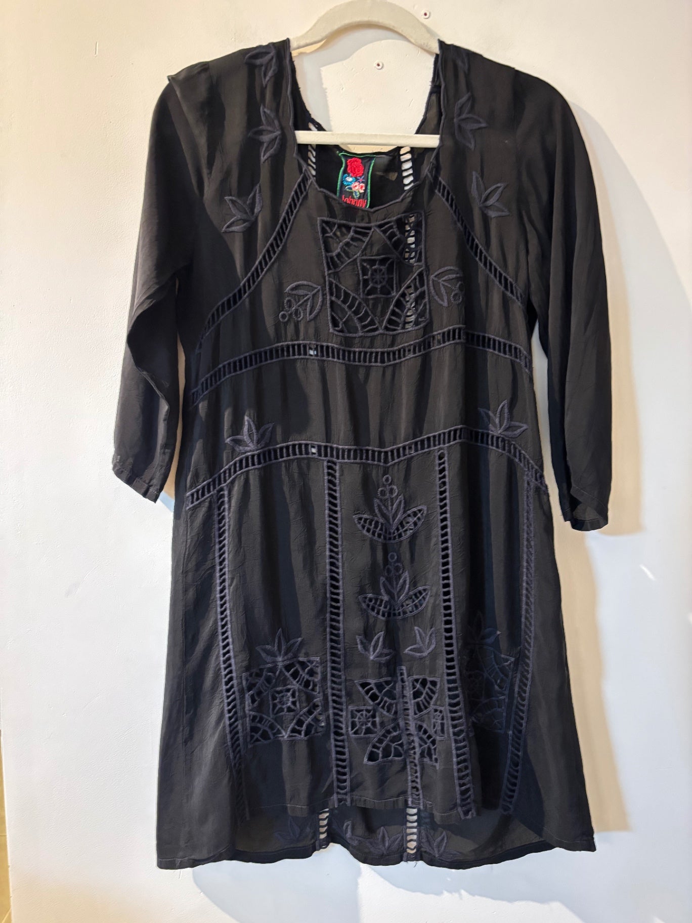 johnny was black embroidered dress ASYMMETRIC RUFFLE FLOUNCE SHORT SLEEVE FIT About 37.5 from shoulder to hem Model measurements Johnny Was Black & Navy